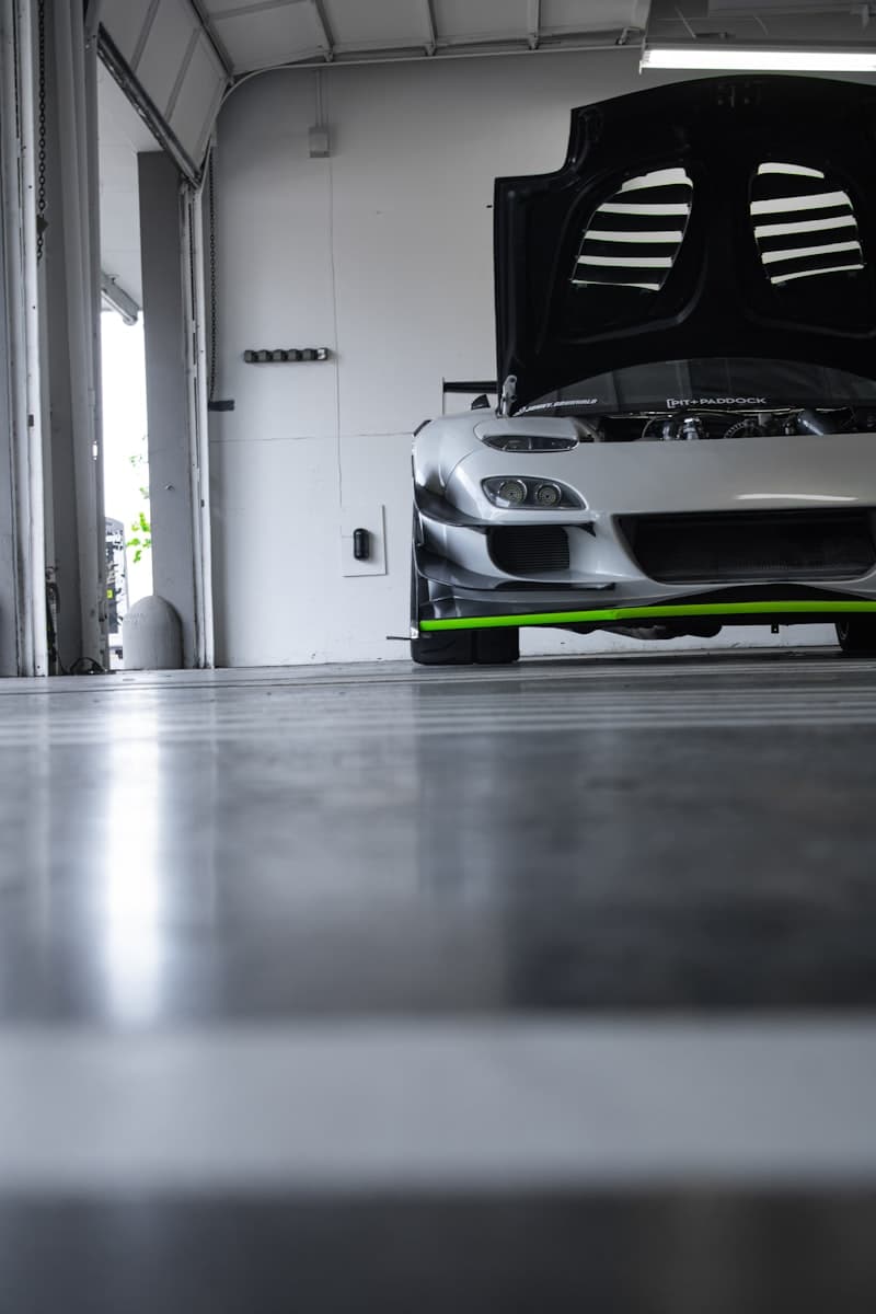 Gray coated floor in a garage with a parked sports car